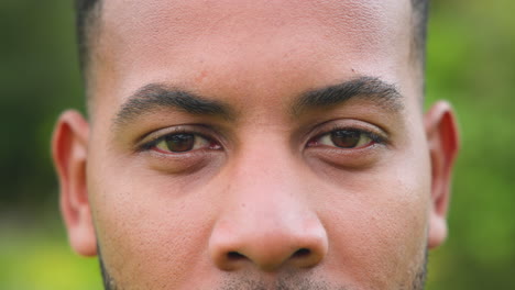 close-up of man's face outdoors, focusing on eyes and expression