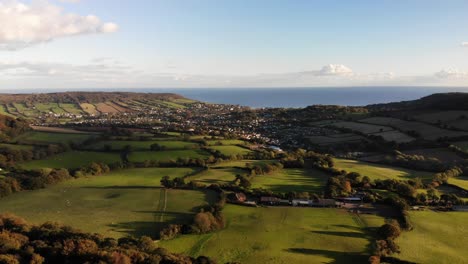 aerial forward moving shot from firebeacon hill looking towards sidmouth and lyme bay devon england uk