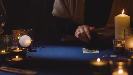 Close-Up-Of-Woman-Giving-Tarot-Card-Reading-On-Candlelit-Table-9