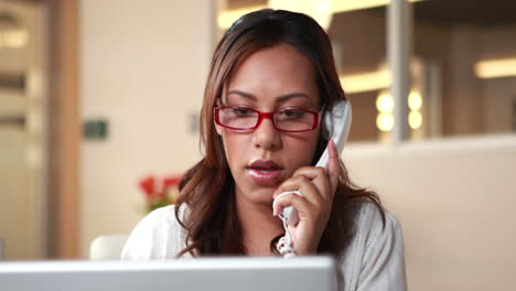 Smiling-casual-businesswoman-having-a-phone-call