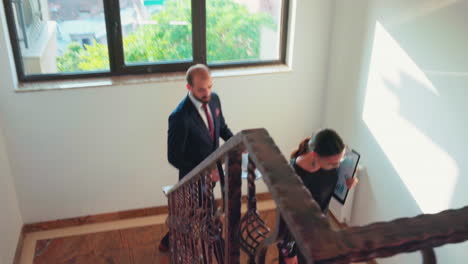 Corporate-business-team-moving-on-busy-stairs-talking