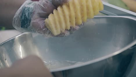 man-with-watch-on-left-hand-takes-out-yellow-fresh-pineapple