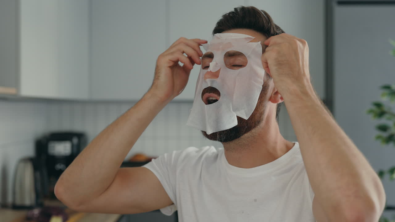 Man Applying a Facial Sheet Mask
