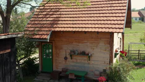 tiny wooden cabin outside the city - aerial descend