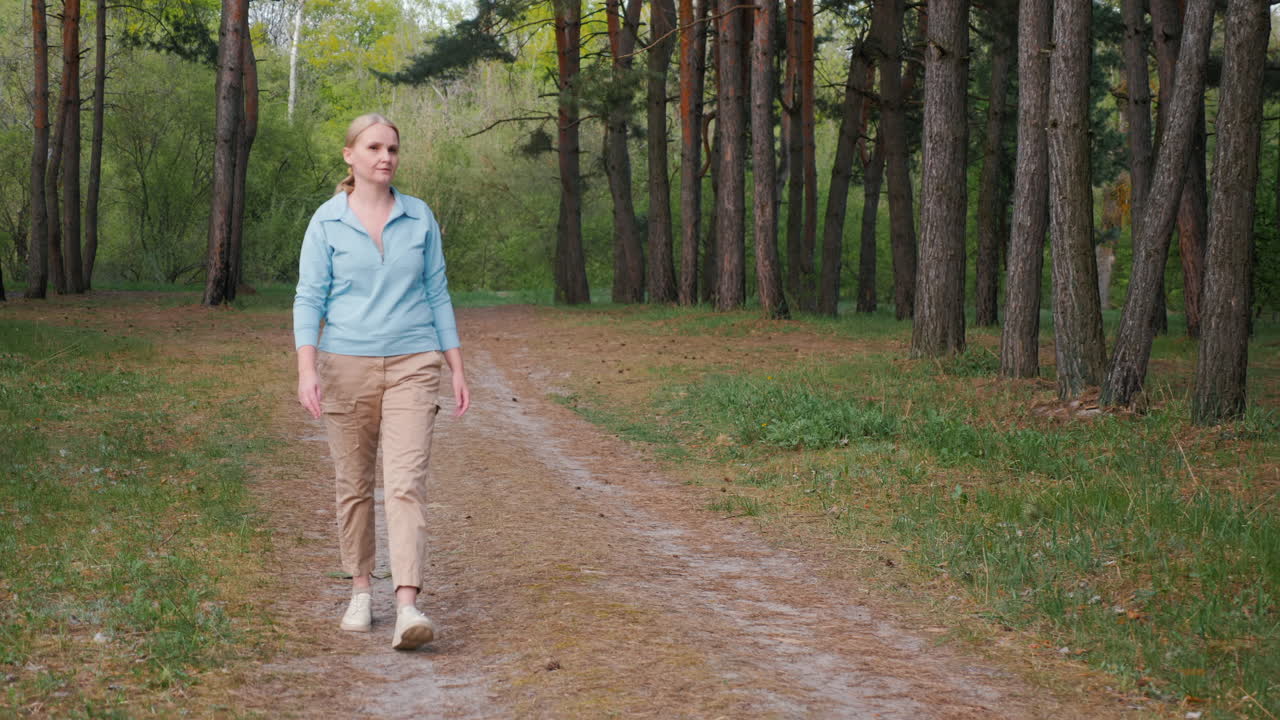 Woman Walking Through a Pine Forest