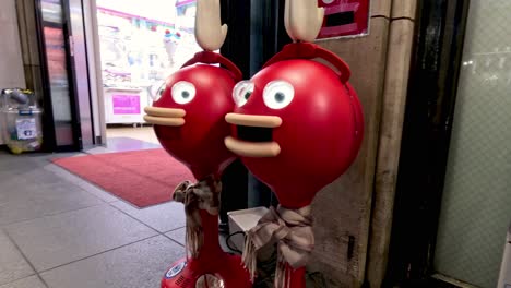 animated balloons with faces by a store entrance