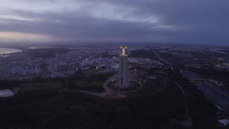 flying towards cristo rei statue lisbon portugal during sunrise, aerial