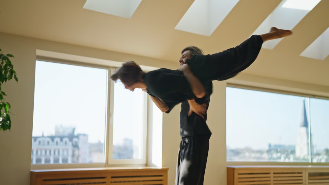 A man and a woman dance in a room