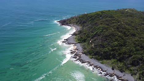 Flying-over-rocky-coastline-showing-a-peninsula-and-the-ocean