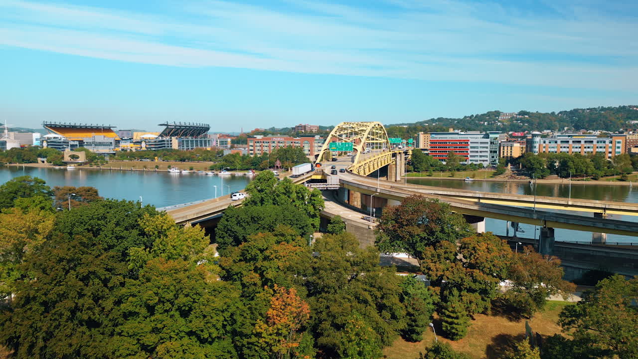 View on the Fort Duquesne Bridge located in Pittsburgh, Pennsylvania, United States. Descending over the green lawn in the park on sunny day