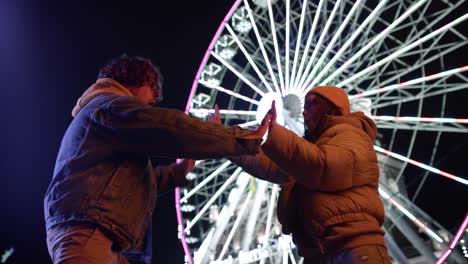 happy couple playing patty cake game outdoor. man and woman having fun outdoor.