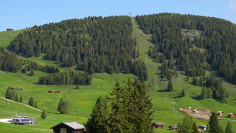 Panning-right-shot-of-Alpe-di-Siusi-green-mountainous-landscape-in-sunny-summer-day