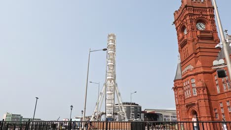 clock tower and ferris wheel in cardiff bay