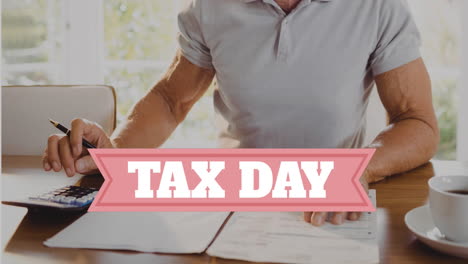 animation of tax day text over caucasian man doing paperwork