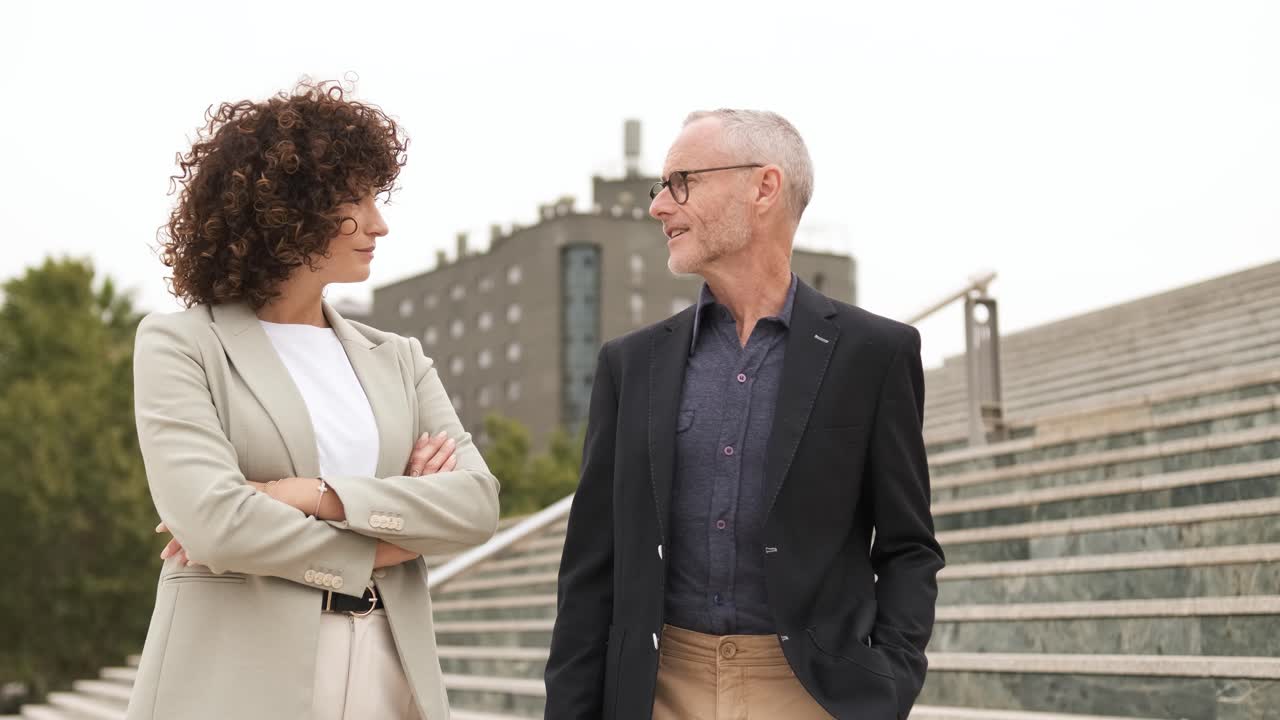 Businesspeople having friendly discussion in city