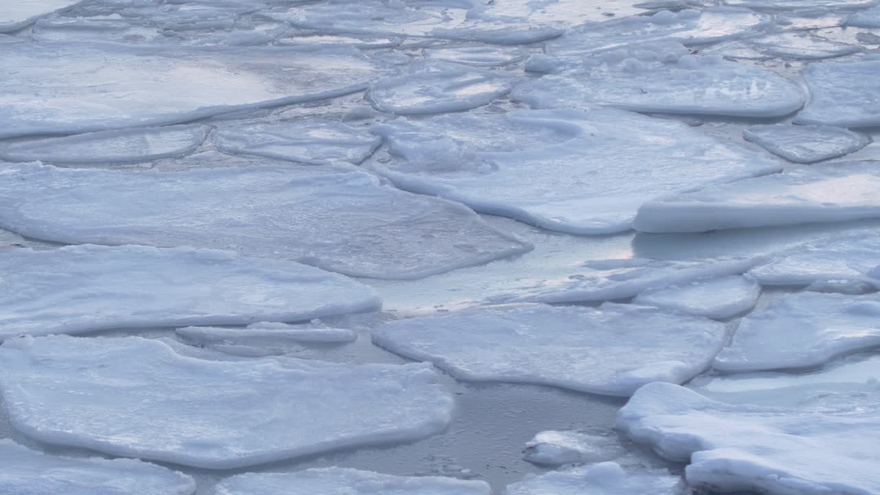arctic northern norway winter , large pieces of melting ice floating on a sea surface, long duration beautiful nature footage