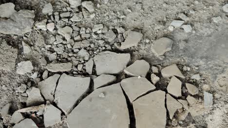 fractured concrete slabs reveal damage, wear on exposed floor at renovation site