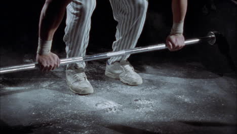 a man lifts a very heavy barbell