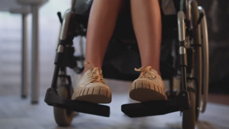 Legs-of-young-woman-with-spinal-paralysis-in-wheelchair