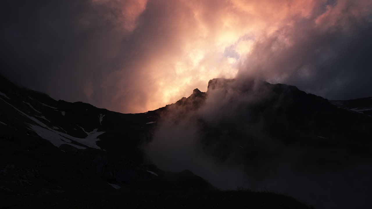 Dramatic Mountain Sunset with Clouds and Mist