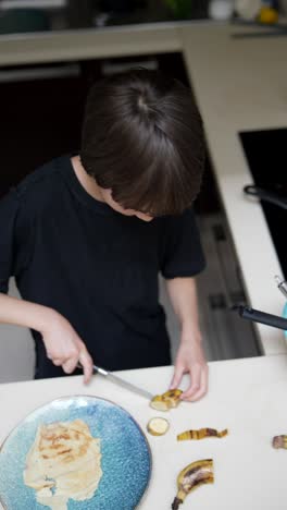 child preparing banana pancakes in the kitchen