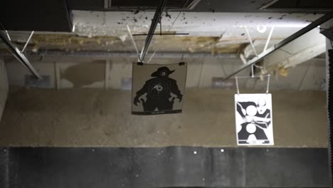 clip of a bullet being shot and propelling forward and hitting a target in the middle at a shooting range