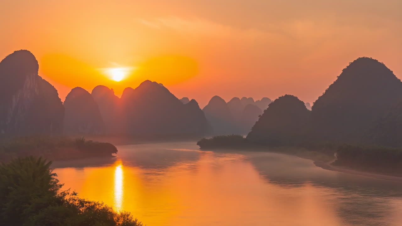 Misty Sunrise over Scenic Karst Mountains and River