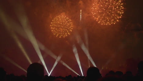 silhouettes enjoying a grand finale of fireworks in the sky
