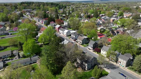 main street with homes of small american town in spring season