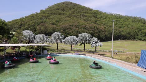 people enjoying bumper boats in a scenic park