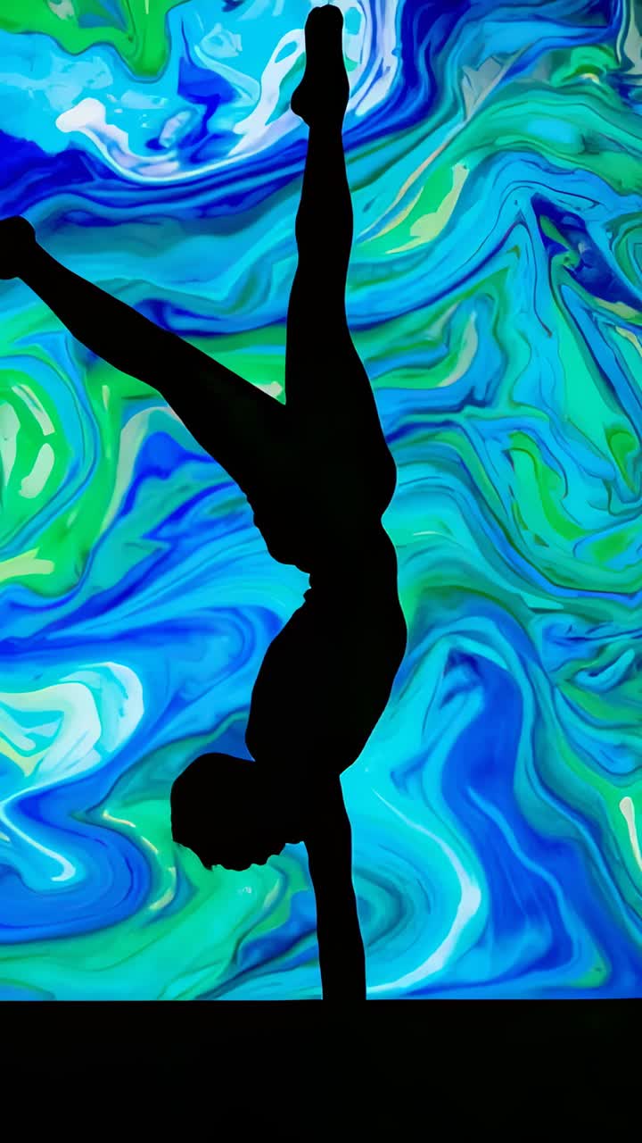 Vertical video: Holding dancer doing onearm handstand on stage on cue to balance in leotard, screen