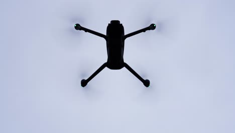 dark drone silhouette hover in air and increase altitude, czech republic