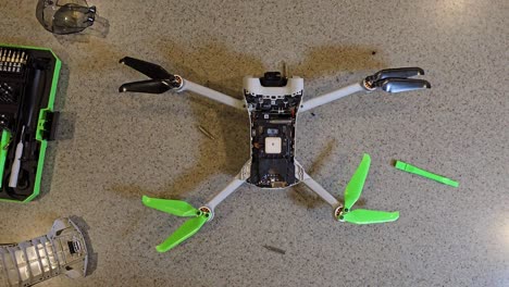 small drone being repaired viewed from overhead