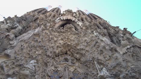 Upward-look-at-the-Nativity-Facade-with-blue-sky-at-La-Sagrada-Familia,-Barcelona