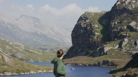 woman-using-smartphone-taking-photos-young-female-tourist-enjoying-beautiful-scenic-river-landscape-sharing-vacation-travel-experience-on-mobile-phone-social-media