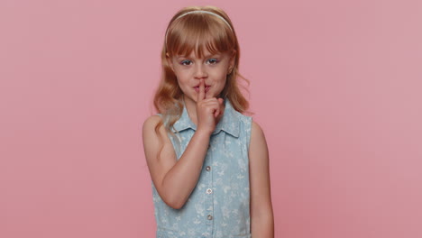 preteen child girl presses finger to lips makes silence hush sign do not tells gossip secret, quiet