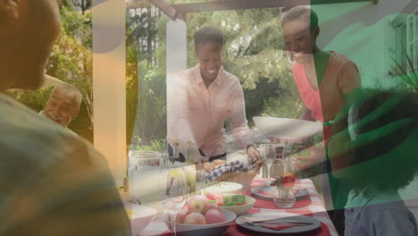 animation of flag of ivory coast over african american family eating dinner together