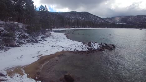 an aerial over the snow covered shores of lake tahoe