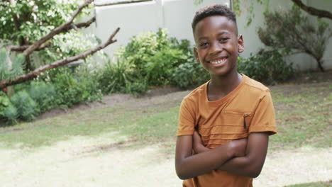 african american boy smiles confidently outdoors, with copy space