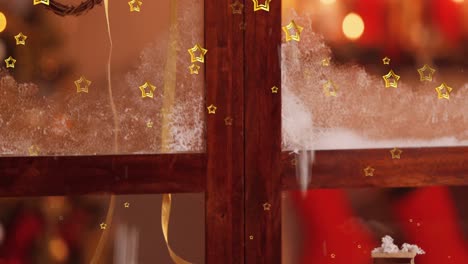 Animation-Von-Sternen,-Die-über-Ein-Winterfenster-Mit-Weihnachtsdekorationen-Fallen