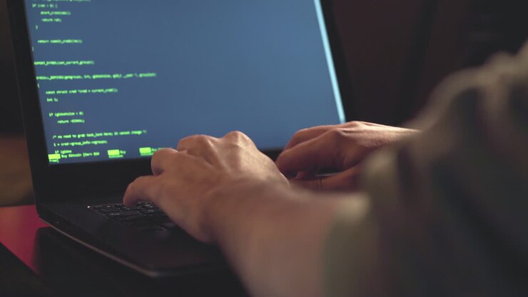 Close up hands developing software app using digital laptop computer typing and coding code on laptop screen
