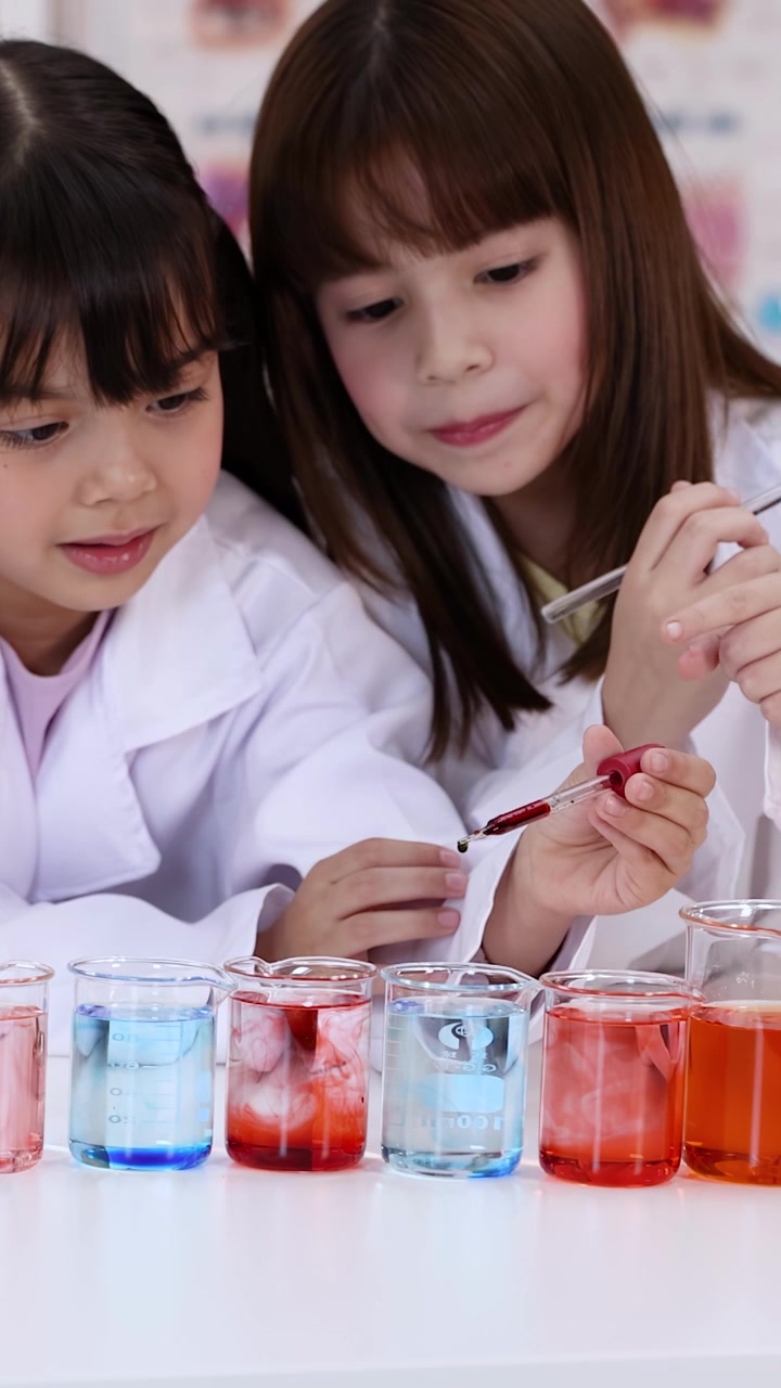 Two Young Girls Conducting Science Experiments in a Laboratory