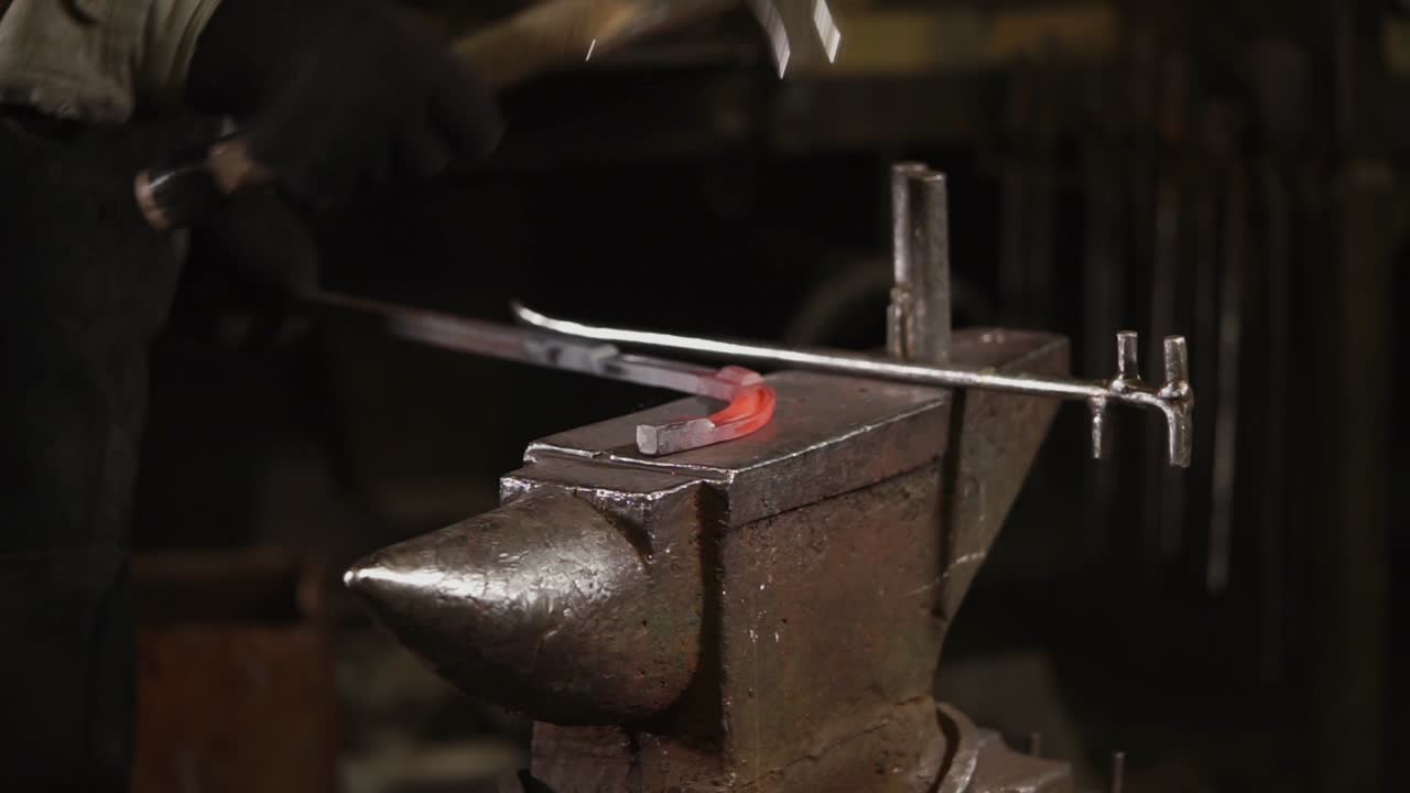 Blacksmith Forging Metal at Anvil
