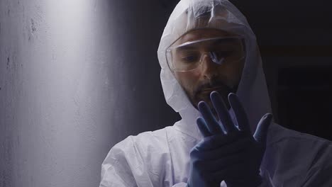 man in protective suit preparing gloves, nuclear disaster concept, face middle shot