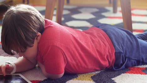 boy using digital tablet in living room 4k