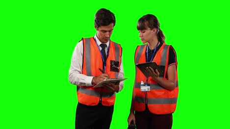 front view of a site workers using digital tablet with green screen