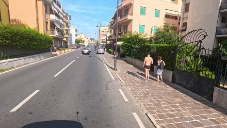 people walking along a sunny street