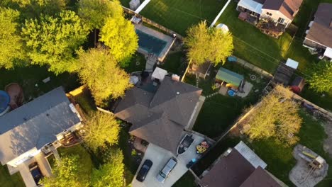 4k aerial shot descending towards the tree line to expose rural homes, cars, swimming pools and more