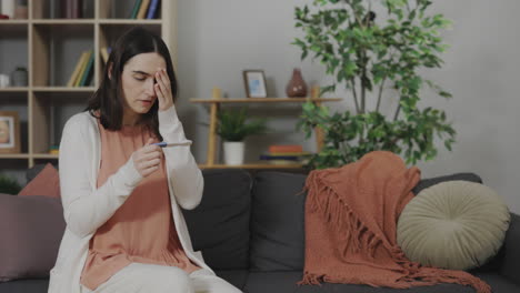 woman looking at pregnancy test