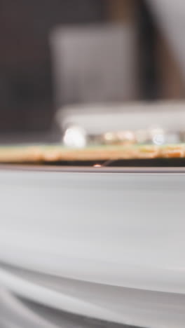 old recorder inserts cassette to spinning head on blurred background extreme close view. analog device to watch video. inside mechanism extreme checkup
